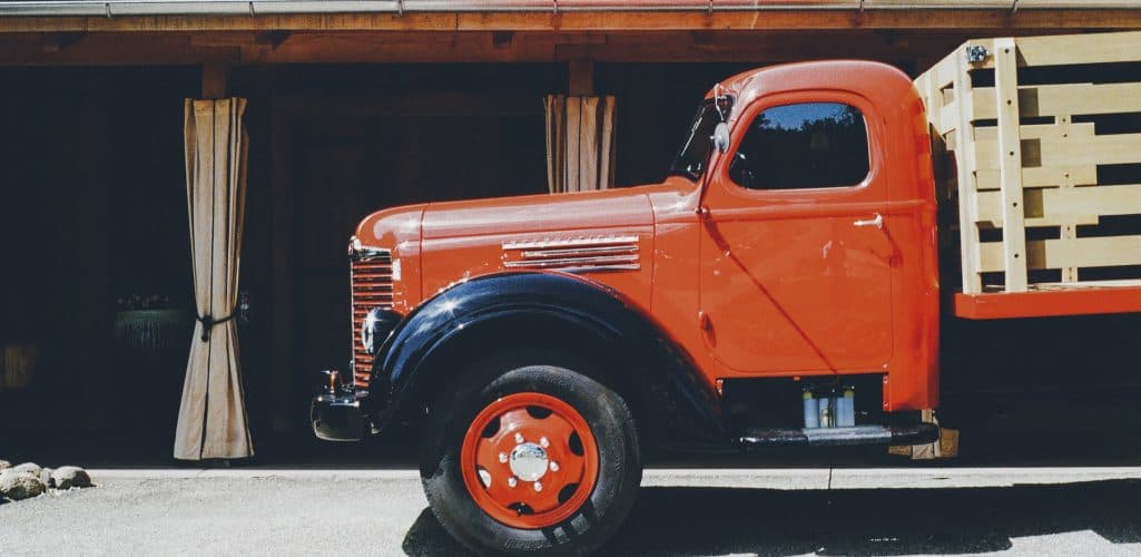 Work truck with ladder rack and tool boxes parked at a commercial job site