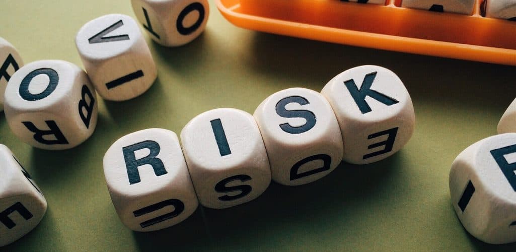 Business owner and advisor reviewing risk management documents at a desk